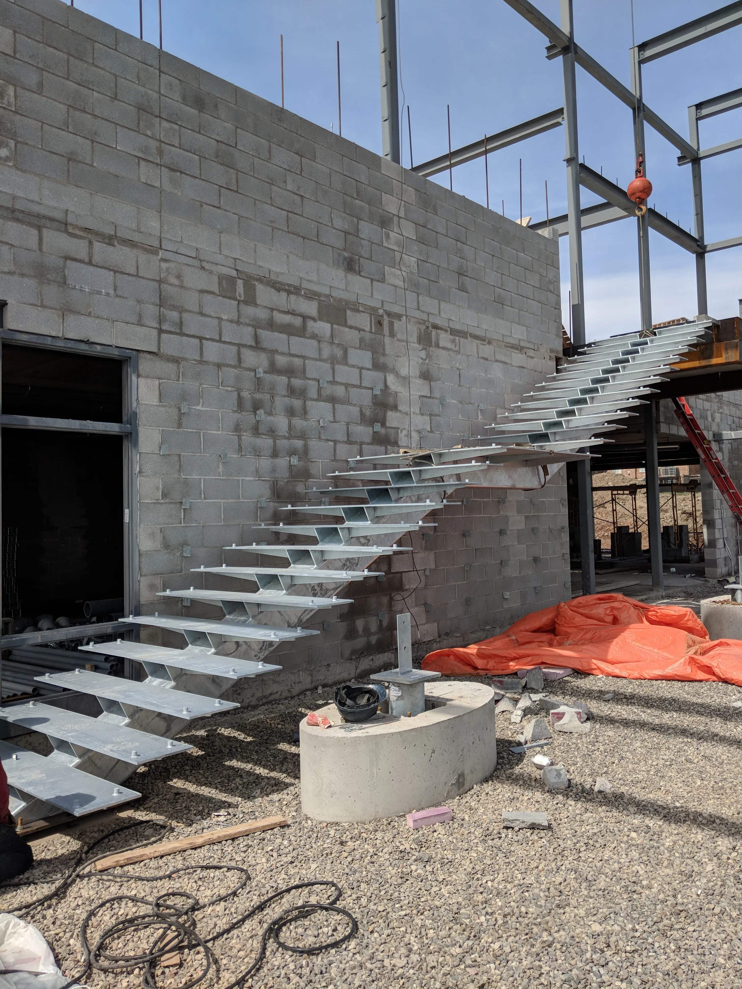 Galvanized steel stair being installed on site.